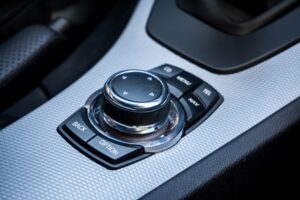A multimedia wheel inside a BMW is used to navigate through the menus.