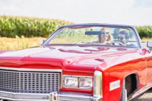 Smiling couple in a red old car