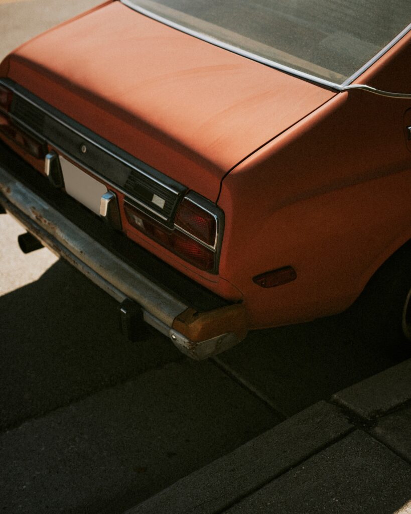 The trunk of a red old car